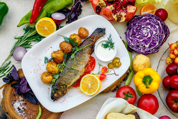 Grilled trout with potato sauce and tomato sauce and jalapeno