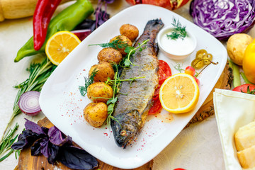 Grilled trout with potato sauce and tomato sauce and jalapeno