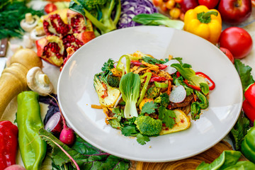 delicious salad with broccoli meat greens with pepper and vegetables, on a decorated table
