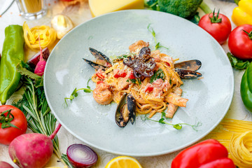 Pasta with seafood, octopus, shrimps and mussels on a decorated table