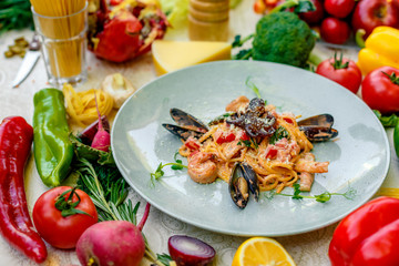 Pasta with seafood, octopus, shrimps and mussels on a decorated table