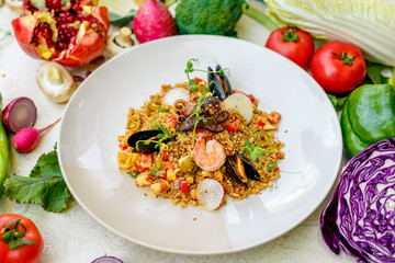 ice risotto with seafood, mussels, shrimps and vegetables, healthy food