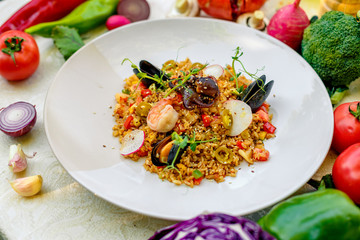 ice risotto with seafood, mussels, shrimps and vegetables, healthy food