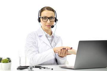 Smart doctor with headset gives online consultation on computer, video call consulting with female nurse using laptop, healthcare concept. Isolated white background, copy space. Patient support