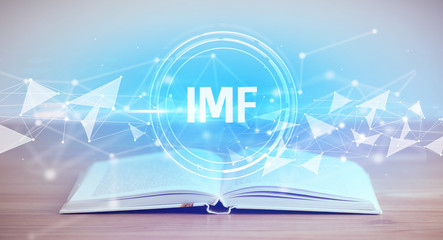 Open book with IMF abbreviation, modern technology concept