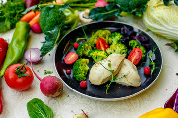 diet food, boiled chicken breast with broccoli and tomatoes on a decorated table