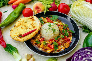 Mexican food, fajitos with vegetables, wheat cake and hot pepper on the table decorated with vegetables