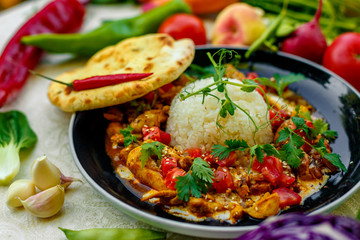Mexican food, fajitos with vegetables, wheat cake and hot pepper on the table decorated with vegetables