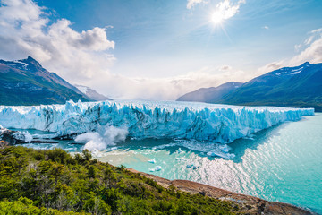 Ice collapsing into the water at Perito Moreno Glacier in Los Glaciares National Park near El Calafate, Patagonia Argentina, South America. - obrazy, fototapety, plakaty
