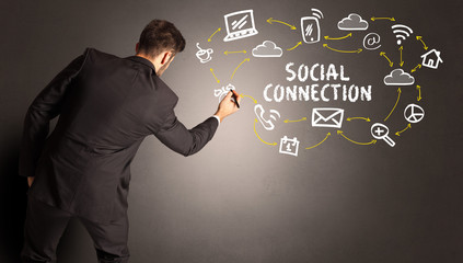 businessman drawing social media icons with SOCIAL CONNECTION inscription, new media concept