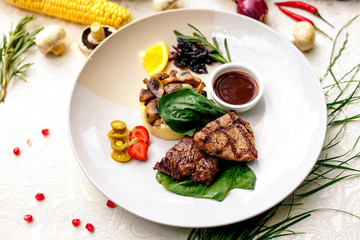 pieces of grilled meat with mushrooms and mashed potatoes