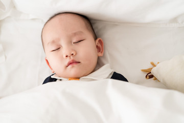 Asian baby sleeping in the room