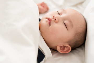 Asian baby sleeping in the room