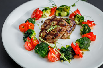 grilled meat with tomatoes and broccoli