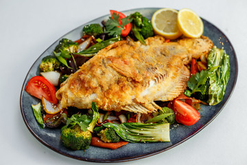 fried trout with lemon and garnish