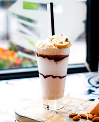 milkshake with chocolate syrup and cookies on top