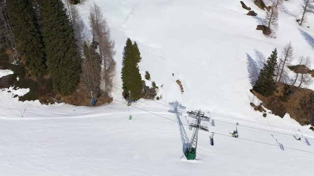 Aerial shot of chair lift in Nassfeld Ski Resort, Austrian province of Carinthia with Skiers on slopes