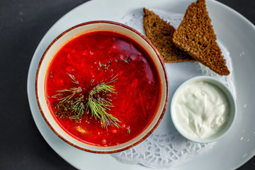 Russian dish borsch with rye bread and sour cream
