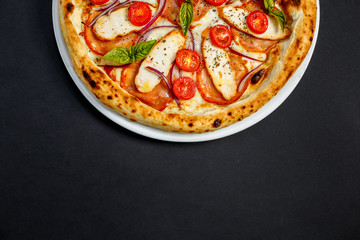 pizza with cheese and chicken with tomatoes