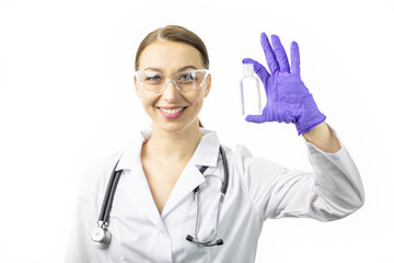 Beautiful smart sexy female doctor in white medical coat and stethoscope holding sanitizer alcohol gel dispenser in hand to prevent spread of bacteria and virus. Care, distancing, protection concept