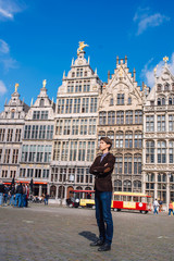 Obraz premium a man on Antwerp square with the city hall and Brabo monument in the Old city,