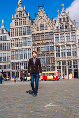 a man on Antwerp square with the city hall and Brabo monument in the Old city,