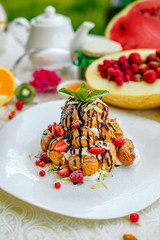 Krekembush - an elegant French profiterole cake topped with chocolate and nuts