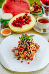 Krekembush - an elegant French profiterole cake topped with chocolate and nuts