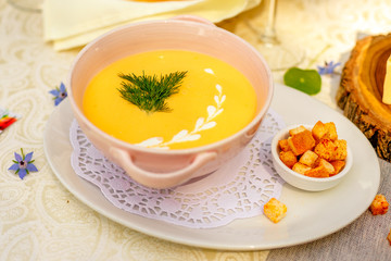 cheese soup with crackers on the holiday table