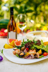 fresh seafood salad with mussels, shrimps, octopus with greens, healthy food