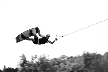 Black and white photo of a wakeboarder in the air, Hungary