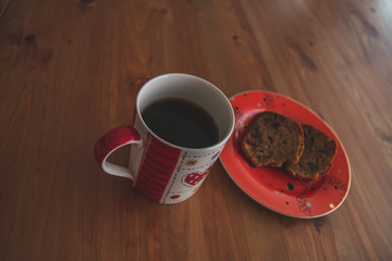 
cake in red plate standing on wooden table base