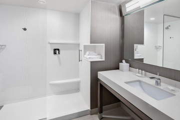 modern bathroom with white towel and sink and shower