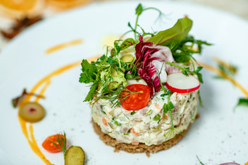 French salad Olivier served on the table
