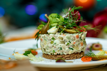 Fototapeta na wymiar French salad Olivier served on the table