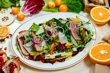 salad with smoked meat and ingredients served on the table
