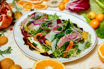 salad with smoked meat and ingredients served on the table