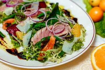 salad with smoked meat and ingredients served on the table