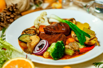 juicy steaks with grilled broccoli vegetables and mushrooms served on the table