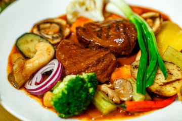 juicy steaks with grilled broccoli vegetables and mushrooms served on the table
