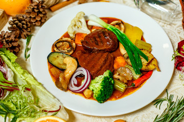 juicy steaks with grilled broccoli vegetables and mushrooms served on the table