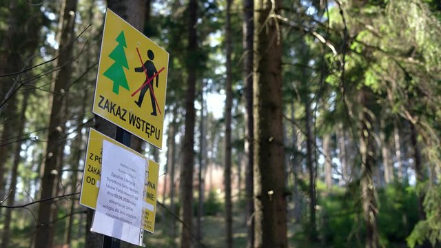 Return of communism in Poland. Information plate with a sign prohibiting entry into the forest. The ban does not comply with the Polish constitution. PIS violates human rights during the coronavirus