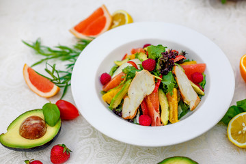 salad with chicken vegetables and herbs, healthy food on the table