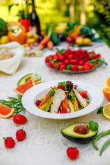 salad with chicken vegetables and herbs, healthy food on the table