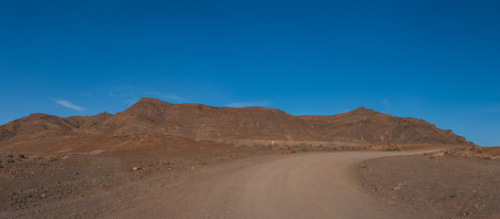 panorama of mountains overlooking the sea in the desert on the Atlantic coast of the island of Fuerteventura. Las Playitas, october 2019