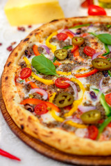 Delicious italian pizza served on table with ingredients cheese and vegetables