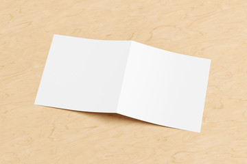 Blank square pages leaflet cover on wooden background. Bi-fold or half-fold opened brochure isolated with clipping path. Side view. 3d illustration