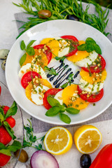 Fototapeta na wymiar fresh vegetarian salad with greens and vegetables on the table, healthy food