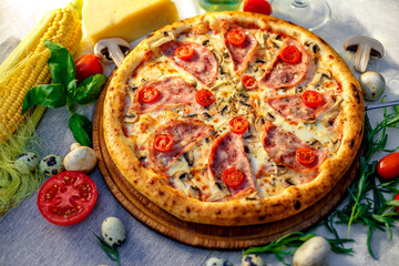 Delicious italian pizza served on table with ingredients cheese and vegetables