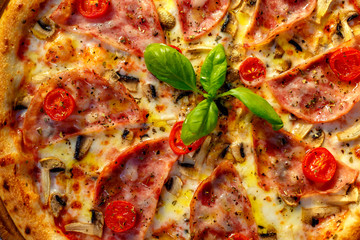 Delicious italian pizza served on table with ingredients cheese and vegetables